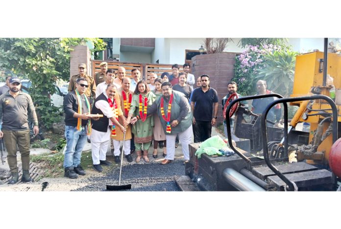 BJP MLAs Vikram Randhawa and Dr D K Manyal kick starting blacktopping work in Channi Himmat on Sunday. BJP MLAs Vikram Randhawa and Dr D K Manyal kick starting blacktopping work in Channi Himmat on Sunday.