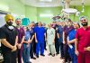 A team of doctors posing together after performing a complex surgery at ASCOMS Jammu.