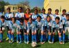 Players pose for a group photograph during the ongoing 68th National School Games U-17 Girls Football Championship at Sainik School Nagrota.