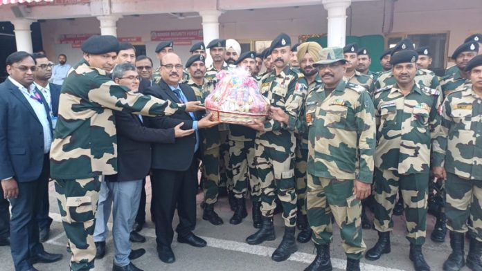 BSF officers greeting SBI officers during their visit at Octroi Post in Suchetgarh Border of Jammu on Thursday.