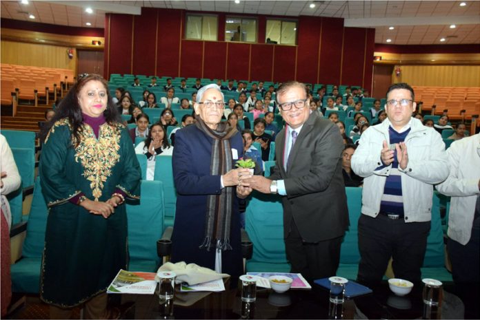 Prof Vishwamurti Shastri presenting memento during seminar at SMVDU.