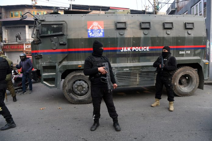 Security forces stand guard in Harwan area of Srinagar during the encounter on Tuesday. -Excelsior/Shakeel Security forces stand guard in Harwan area of Srinagar during the encounter on Tuesday. -Excelsior/Shakeel