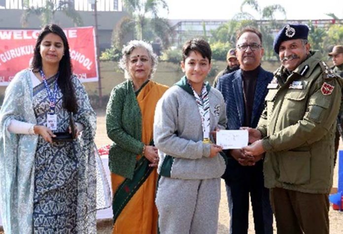 DIG Jammu-Samba-Kathua Range, Shiv Kumar Sharma presenting award to a student.