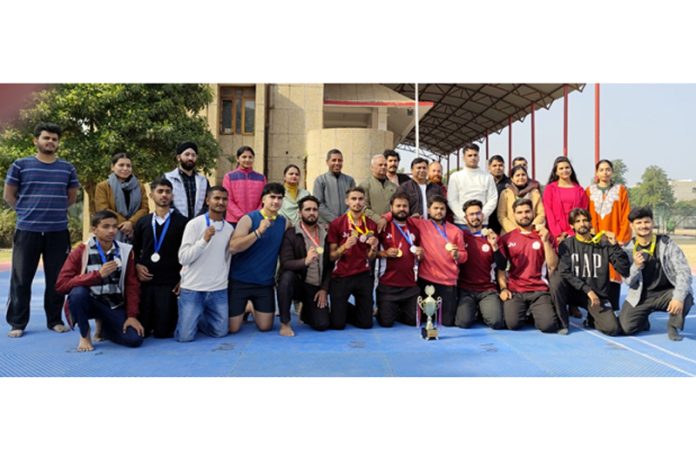 Winners posing along with dignitaries during Inter-Collegiate Yoga Championship at Jammu University.