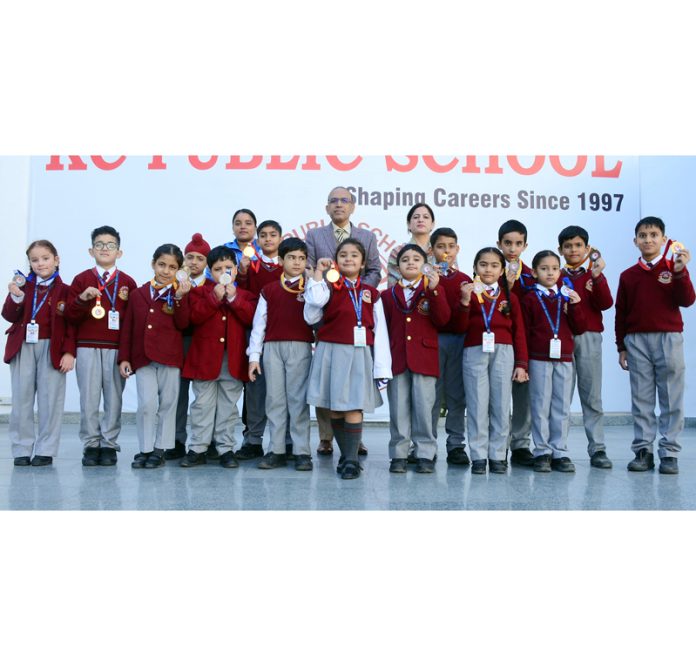 Students of KC Public School posing with medals.