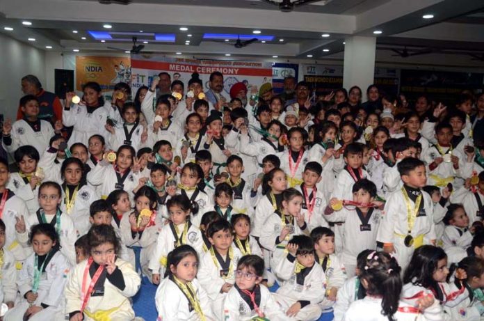 Taekwondo players posing for group photograph during an event at Jammu.