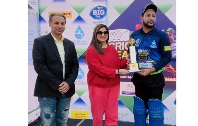 Player receiving man of the match award from a dignitary.