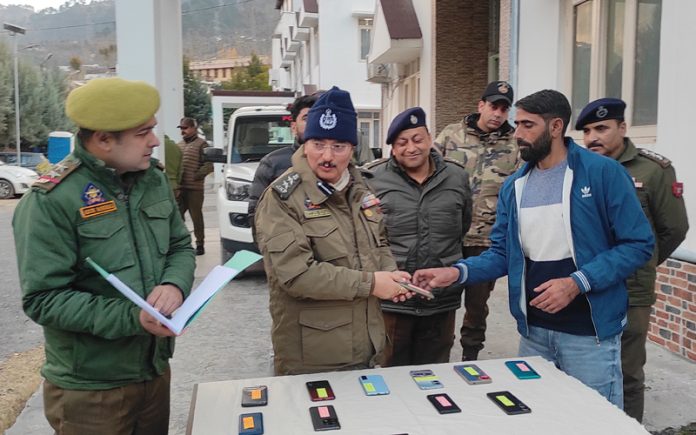 SSP Ramban hands over recovered phones to their owners on Monday. — Excelsior/Parvez