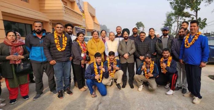 Director General Youth Services and Sports J&K, Rajinder Singh Tara posing along with medallists and others.
