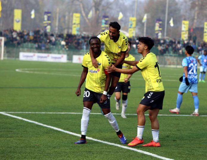 Football players celebrating after scoring a goal during an I-League match at the TRC Ground in Srinagar.