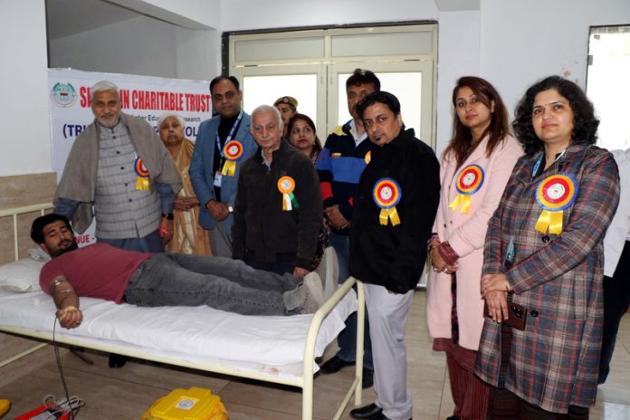 MLA Sham Lal Sharma posing along with others during a Blood Donation Camp organized in Jammu on Monday.