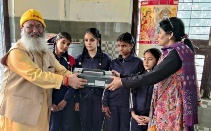 000Dr Sushil Wattal head of Puruppkar Trust distributing heat converters among the children of Girls School Roopnagar.