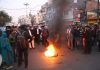 Protesting advocates burning a tyre on the Janipur road on Monday. — Excelsior/Rakesh
