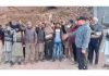 Locals staging protest over poor condition of Akhori-Patti Planghar Road in Rajouri.