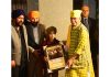 LG felicitating a child of Sikh community on Thursday.