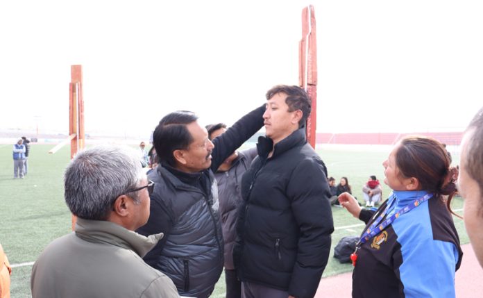 Height measurement of a candidate being done by officials during physical tests for recruitment of Excise Guards at Leh.