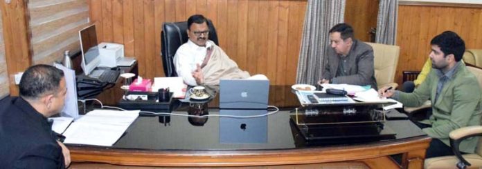 Minister Javed Rana chairing a meeting in Jammu on Thursday.