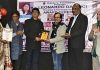 Sculptor Artist Naresh Kumawat honouring Ganesh Sharma during an event on Saturday.
