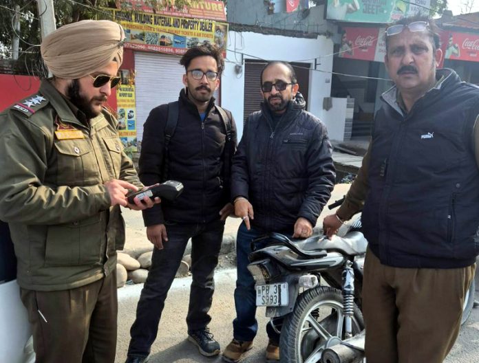 A team of RTO Jammu checking vehicles on Tuesday.