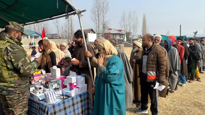 Jawans providing free medicines to people during a medical camp organised in Baramulla on Saturday.