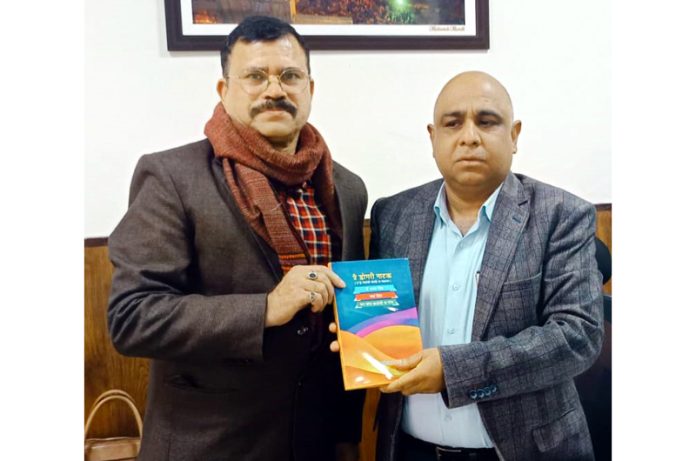 Dr Sudhir Mahajan, prominent writer presenting Dogri Natak book to Pr Secy Culture and Education. Suresh Gupta in Jammu on Wednesday.