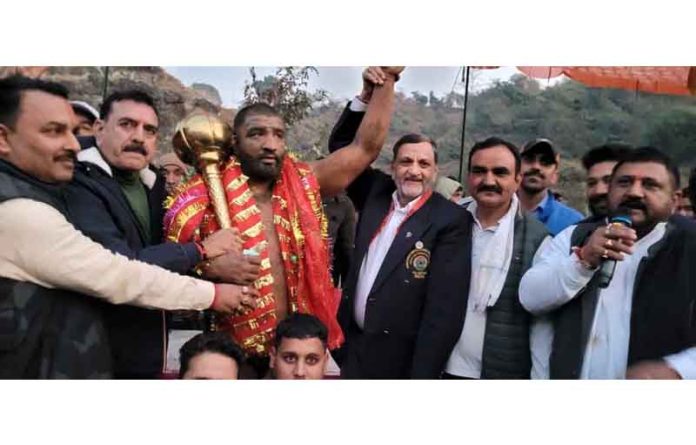Dignitaries posing along with winning wrestler at Reasi on Friday.