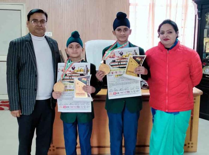 Unique International Public School students posing along with medals.