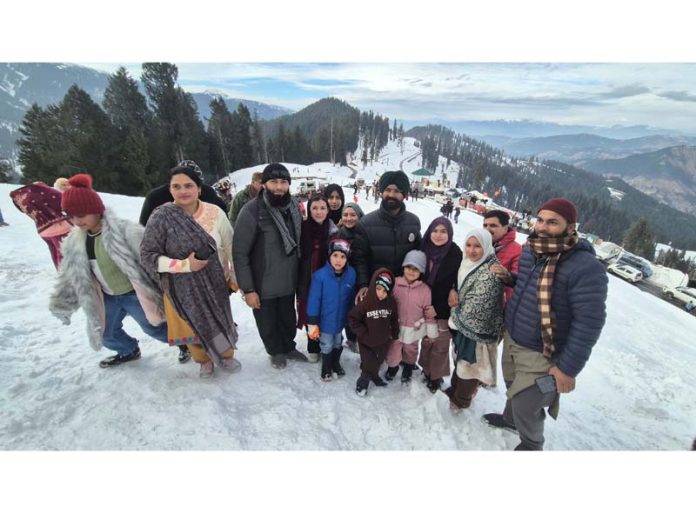 Tourists posing for a group photograph at Guldanda snow meadow in Bhadarwah on Sunday. -Excelsior/Tilak Raj