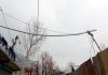 Electric wires on wooden poles and trees pose a danger in Bonezel Machan village of Ganderbal. -Excelsior/Firdous