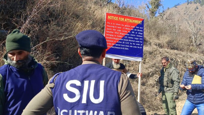 An SIU team of Kishtwar police attaches property of a terrorist. — Excelsior/Tilak Raj