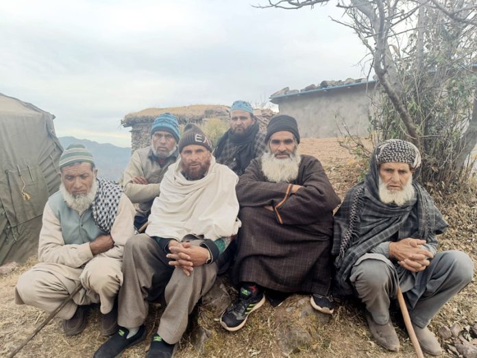 Shocked and scared villagers at Badhaal in Rajouri. — Excelsior/Imran