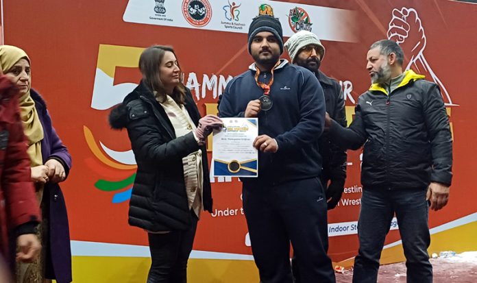 Winner Arm Wrestler posing along with medal and a certificate during prize distribution ceremony at Srinagar on Sunday.