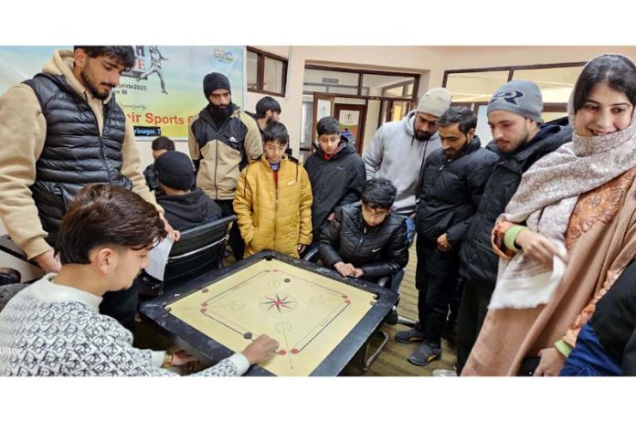 Dignitaries keenly observing a game on opening day of District Srinagar Carrom Championship at SKISC.