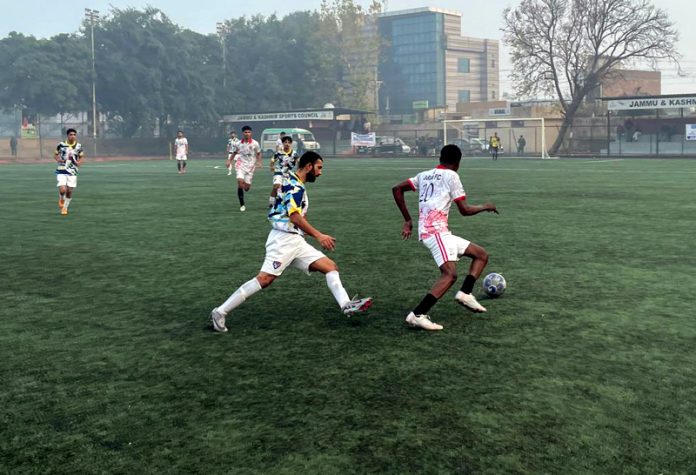 Players in action during football match between Param FC and Shaheen FC at Parade Ground, Jammu.
