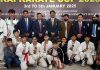 Dignitaries pose alongside Karate players during the North West Kai Karate Cup 2025 at Kurukshetra.