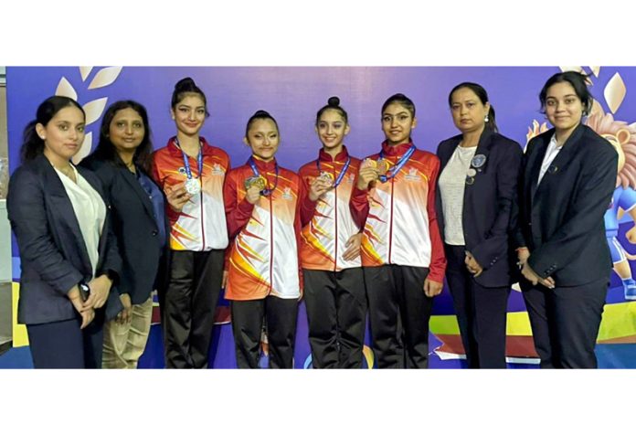 J&K gymnasts posing along with medals and coaching staff at Surat, Gujarat. J&K gymnasts posing along with medals and coaching staff at Surat, Gujarat.