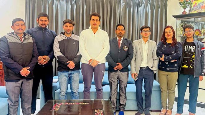Newly elected office bearers of Jammu District Karate Association along with others pose for a photograph.