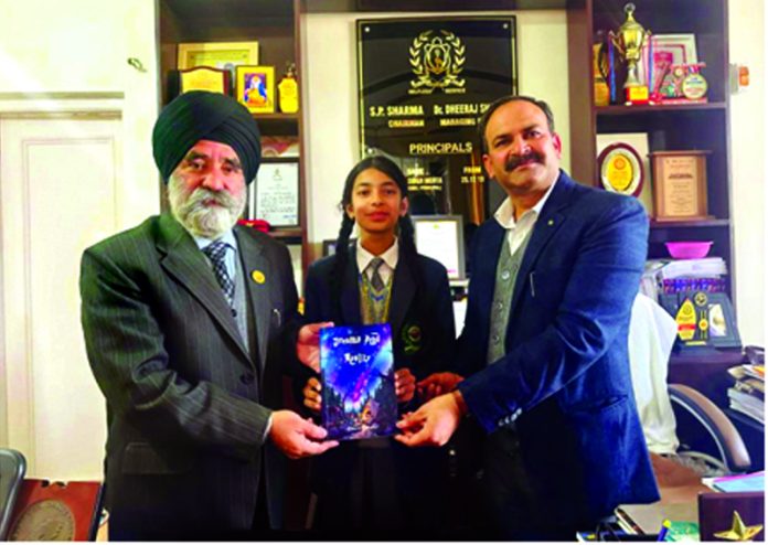 Pehal Rajput posing with Principal Dr. KCS Mehta and Vice Principal Vinay Khajuria along with her debut book “Dreams and Reality.”