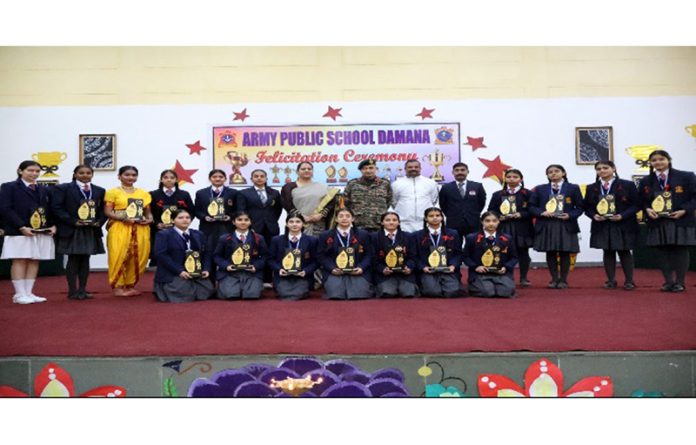 Dignitaries posing along with students during felicitation programme.