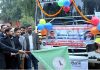 Minister Satish Sharma flagging off special bus service to Prayagraj.