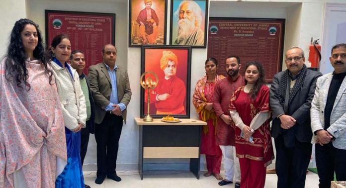 Organizers standing before a portrait of Swami Vivekananda during Yuva Shakti Mahotsav valedictory function at CUJ.