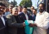 Transport Commissioner Vishesh Paul Mahajan presenting a dustbin to a bus driver at Transport Yard, Narwal in Jammu.