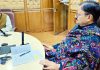 Minister Javed Rana being briefed by an officer.