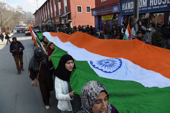 ABVP activists holding 50 feet long national flag in the city center of Lal Chowk in Srinagar. -Excelsior/Shakeel ABVP activists holding 50 feet long national flag in the city center of Lal Chowk in Srinagar. -Excelsior/Shakeel