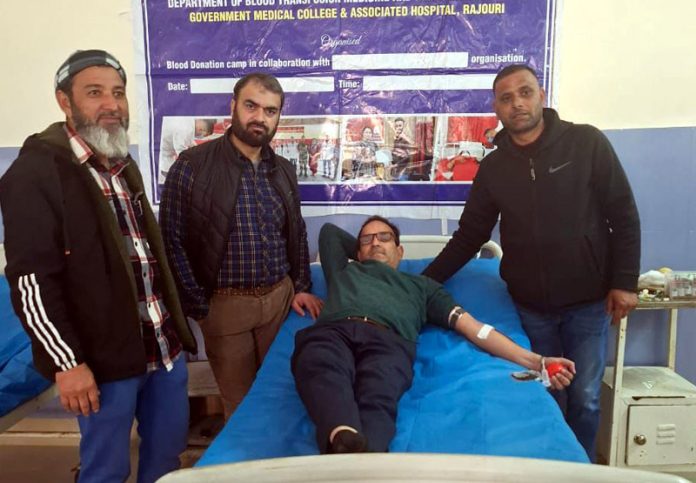 A staff member donating blood during blood donation camp at BGSBU in Rajouri.