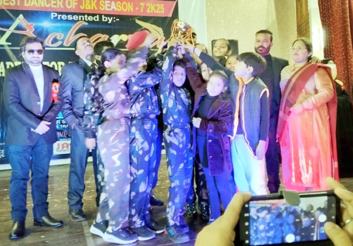 Winning team posing along with trophy. Winning team posing along with trophy.