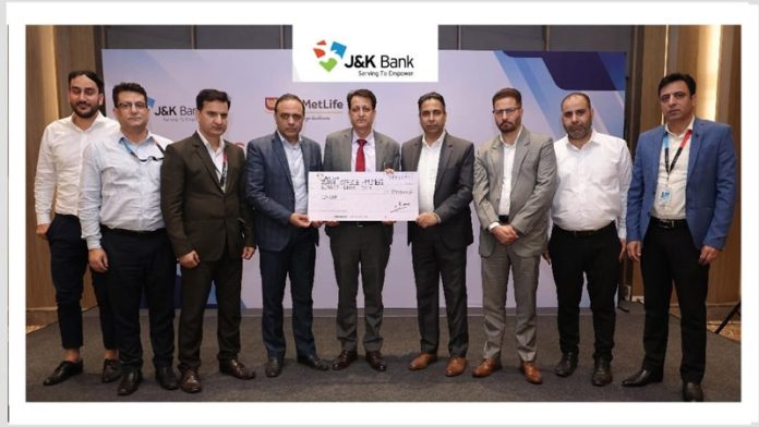 GM & Divisional Head (ROI) of J&K Bank, Rajesh Gupta along with other senior executives displaying a symbolic cheque of Rs 80 lakh.