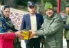 An Army officer presenting a gift to a 'veer nari' during Ex-Servicemen rally in Kishtwar district.
