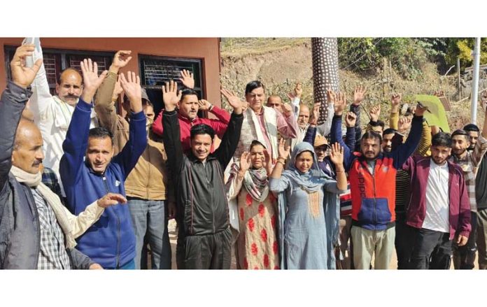 Col Mahan Singh, flanked by villagers, during his visit to different villages of Kathua district on Friday.