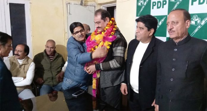Newly nominated PDP migrant wing president Sunil Bhat being honoured at party office in Jammu.